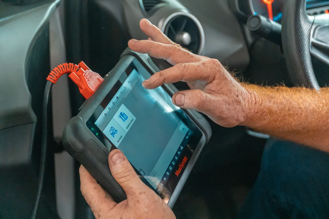 Handheld diagnostic scanner used to check a vehicle
