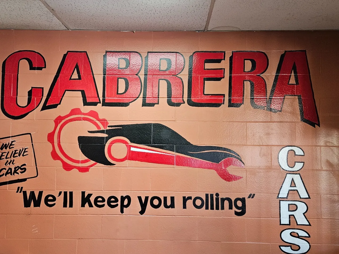 Cabrera’s painted car and wrench mural inside the shop